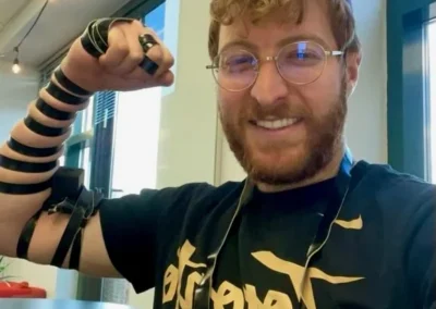 A smiling man wearing tefillin takes a selfie