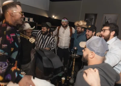 Men in costumes, including cowboy hats and a referee shirt, gathered in a circle